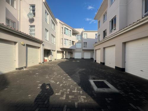 a shadow of a person walking down a street at Haus Helios Eight Central in Swakopmund