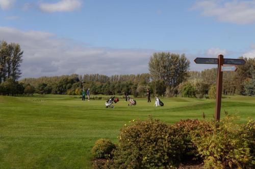a group of people playing golf in a field at Doubletree by Hilton Belfast Templepatrick in Templepatrick
