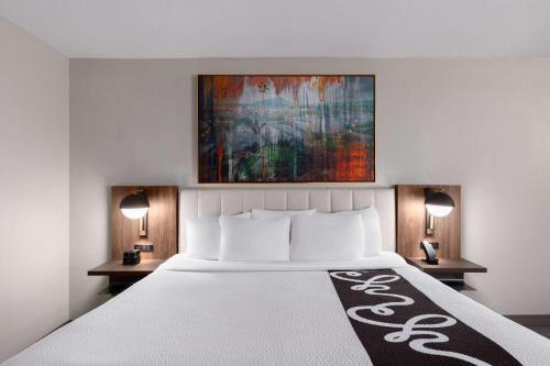 a bedroom with a large bed with two night stands at La Quinta by Wyndham Knoxville Central Papermill in Knoxville