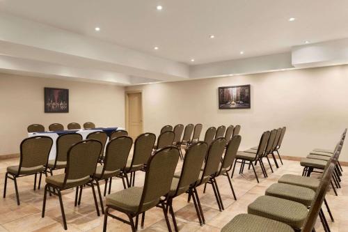a conference room with a table and chairs at Days Inn by Wyndham Montreal East in Montréal
