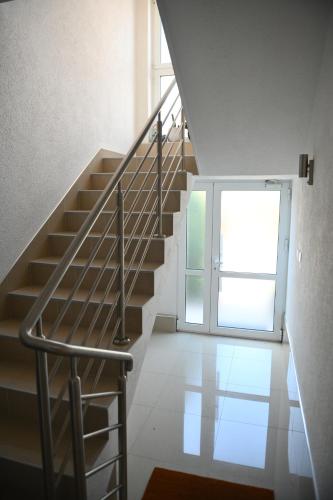 a staircase in a house with a glass door at Apartman MN Teslic in Teslić