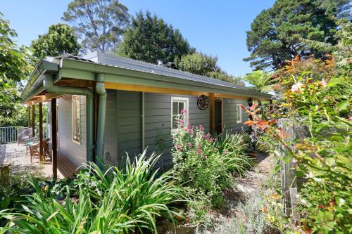 a green tiny house in a garden at Blue Mountains Bliss Cottages Katoomba - Rosebud in Katoomba