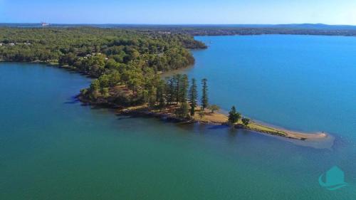 an island in the middle of a large body of water at Serendipity in Eraring