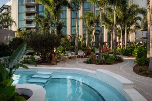 オーランドにあるConrad Orlandoのヤシの木と建物のあるプール