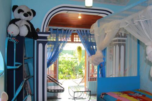 a bedroom with a panda bear on top of a bed at Familyhouse in Negombo