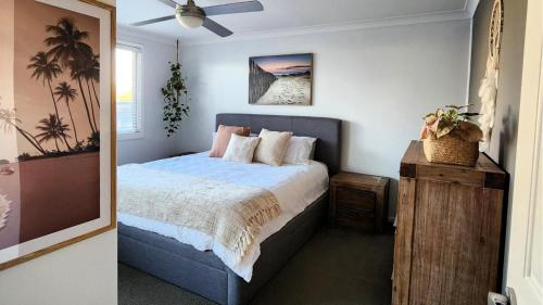 a bedroom with a bed and a ceiling fan at Pelican Lake Retreat in Pelican Flat