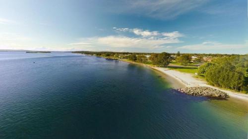an aerial view of a river with a beach at Pelican Lake Retreat in Pelican Flat
