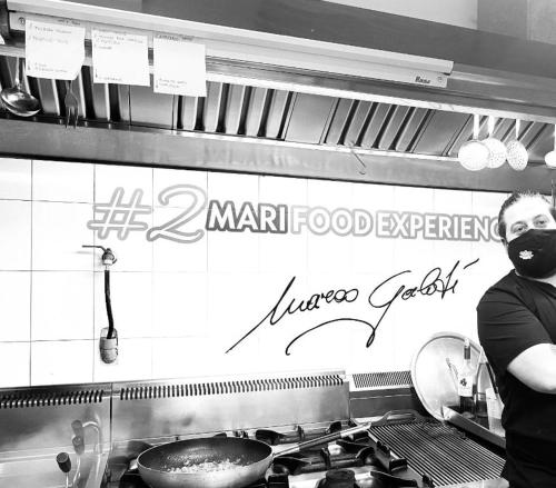 a man wearing a mask standing in a kitchen at Affittacamere 2 Mari in Marina di Leuca
