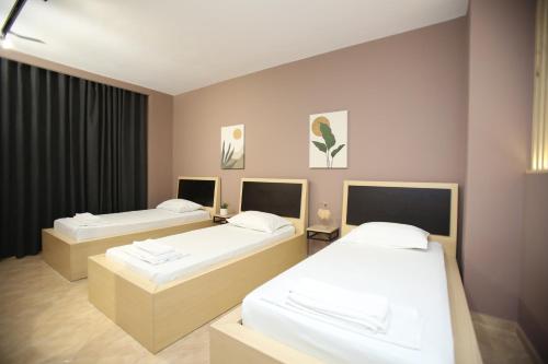 a room with two beds in a room at TekB Rooms & Apartments in Vlorë