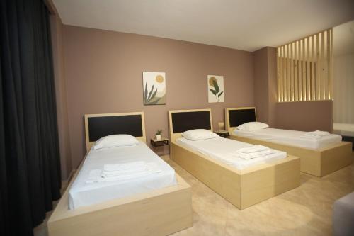 a room with two beds in a room at TekB Rooms & Apartments in Vlorë