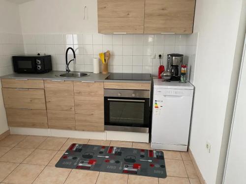 a kitchen with a stove and a white refrigerator at Appartement proche du centre Béthune in Béthune