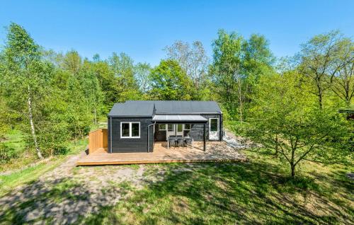 a black tiny house in the woods at Awesome Home In Give With Wifi in Give