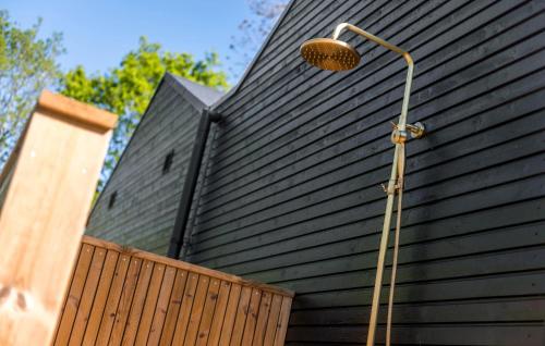 a shower on the side of a black building at Awesome Home In Give With Wifi in Give