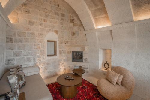 a living room with a couch and a table at Via Regia Cappadocia Hotel in Uchisar
