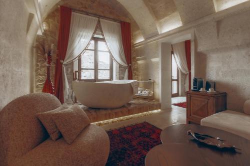 a large bathroom with a large tub in a window at Via Regia Cappadocia Hotel in Uchisar
