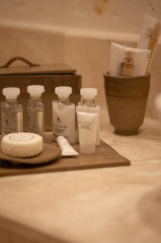 a group of four bottles of soap on a counter at Via Regia Cappadocia Hotel in Uchisar