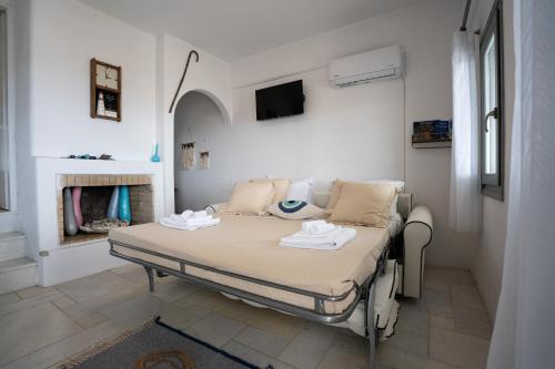 a hospital bed in a room with a fireplace at Martha's filoxenia in Drios