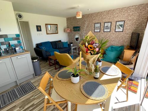 a kitchen and living room with a table and chairs at 187 Needles Lodge in Freshwater