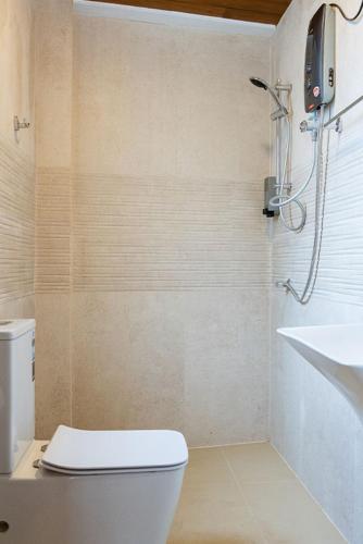 a bathroom with a toilet and a sink at Waterfall Villa by Opulence in Talawakele