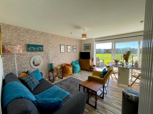 a living room with a blue couch and a table at 187 Needles Lodge in Freshwater