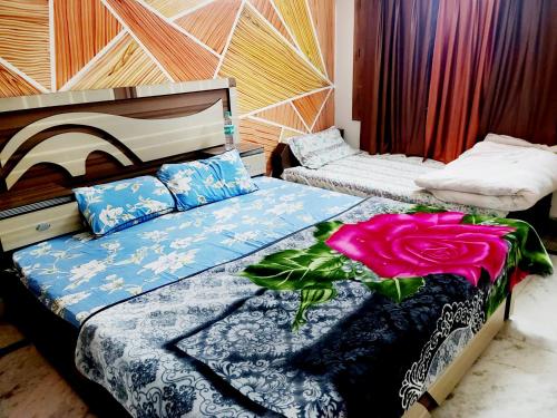 a bedroom with a bed with a rose on it at Hotel Hari Krishnashrya in Vrindāvan