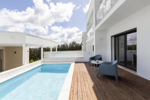 a house with a swimming pool and a patio at 3BR Oasis With Pool by LovelyStay in Vale Covo