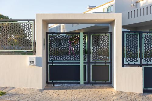 a garage door with a gate in front of a building at Kallisti Stay in Artemida