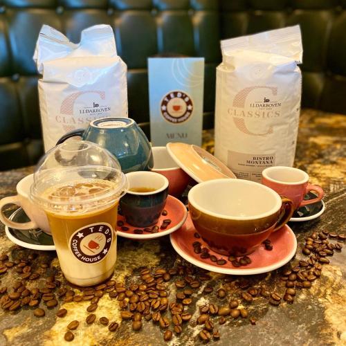 a table topped with cups of coffee and coffee beans at Kilkenny House Boutique Hotel in Kilkenny
