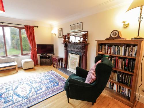 a living room with a chair and a fireplace at Tudor Lodge in Newcastle