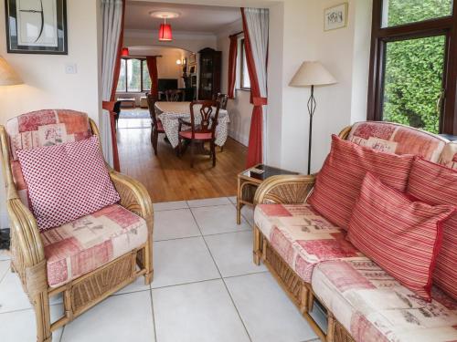 a living room with two chairs and a couch at Tudor Lodge in Newcastle