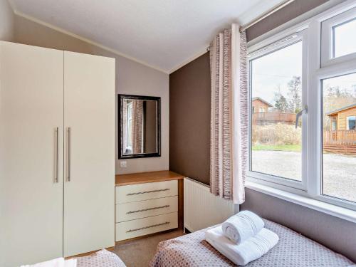 a bedroom with a bed and a window at 3 Bed in Banchory 94062 in Strachan