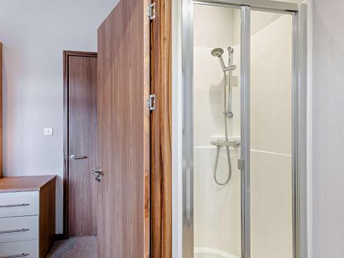 a bathroom with a shower with a glass door at 3 Bed in Banchory 94062 in Strachan