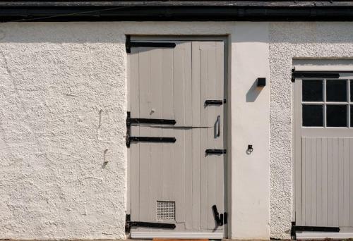 a white door on a building with a window at The Old Stables in Newcastle upon Tyne