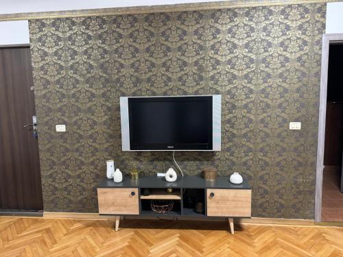 a living room with a tv on a wall at Muresenilor Residence in Braşov