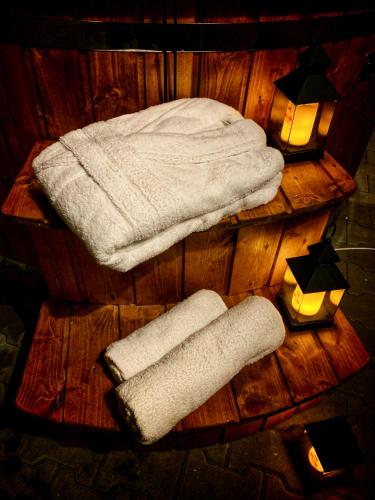 two towels and two lights on a wooden table at Vila Svistovka in Stará Lesná