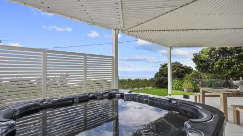 a plunge pool in a backyard with an umbrella at 'A Beachside Getaway - 8' by HolidayCo in Killcare