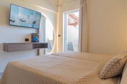 a bedroom with a bed and a window at Missiria Apartments in Rethymno Town