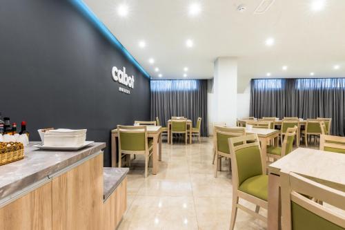 a restaurant with tables and chairs and a sign on the wall at Cabot Playa Grande - Adults Only in Playa de Palma