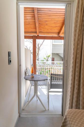 a glass door leading to a patio with a table at Missiria Apartments in Rethymno Town
