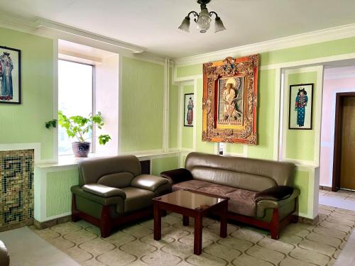 a living room with a couch and a table at Kharaa Hotel & Restaurant in Ulaanbaatar