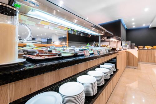 a buffet line with white plates and food at Cabot Playa Grande - Adults Only in Playa de Palma