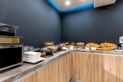 a buffet line with many different types of food at Cabot Playa Grande - Adults Only in Playa de Palma