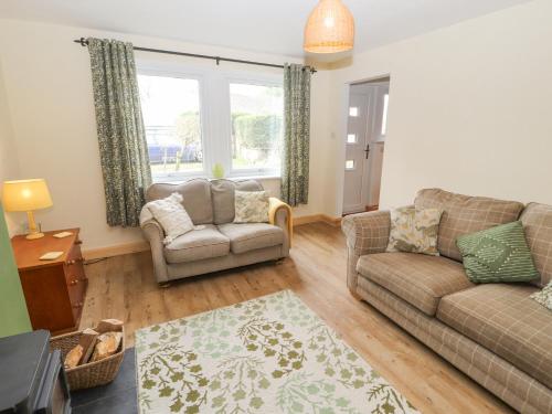 a living room with a couch and a chair at 32 Friar Row in Wigton