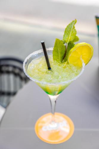 a martini glass with a lime and mint garnishment at Cabot Playa Grande - Adults Only in Playa de Palma