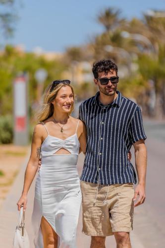 a man and a woman walking down a street at Cabot Playa Grande - Adults Only in Playa de Palma