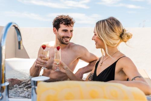 a man and woman drinking champagne in the bathtub at Cabot Playa Grande - Adults Only in Playa de Palma
