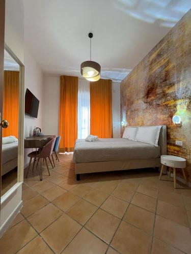 a bedroom with a bed and a table in it at Le Corti del Re in Naples