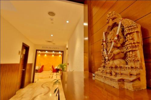 a large statue in a hallway of a building at Hotel The Amaris in Rishīkesh