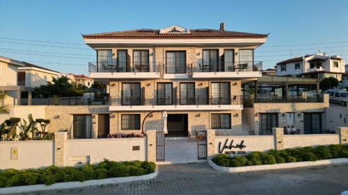 a large house with a gate in front of it at Vahide Dalyan in Cesme