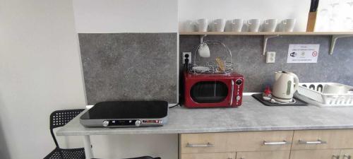 a kitchen with a microwave and a laptop on a counter at Parkcentrum lowcost hotel near center of Ostrava in Jáma Jindřich